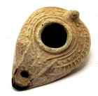 AN ISLAMIC TERRACOTTA OIL LAMP WITH CHRISTIAN ICONOGRAPHY