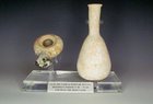 A HERODIAN TERRACOTTA OIL LAMP AND ALABASTRON FROM THE TIME OF CHRIST