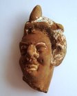 A HELLENISTIC TERRACOTTA HEAD OF A WOMAN OR A GODDESS