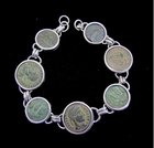 SEVEN JEWISH AND CHRISTIAN BRONZE COINS  IN SILVER BRACELET
