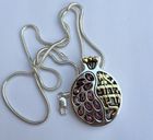 A HANDMADE SILVER PENDANT WITH GARNETS AND GOLD HEBREW INSCRIPTION