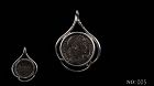 A ROMAN COIN OF CONSTANTINE THE GREAT IN SILVER TREFOIL PENDANT
